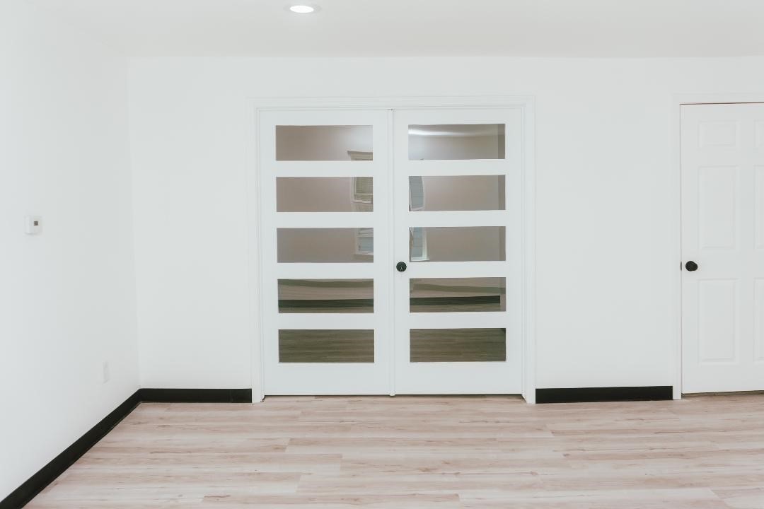 2513 Avenue H Rosenberg, TX 77471 - Photo 6 of 9 a view of an empty room with wooden floor and closet