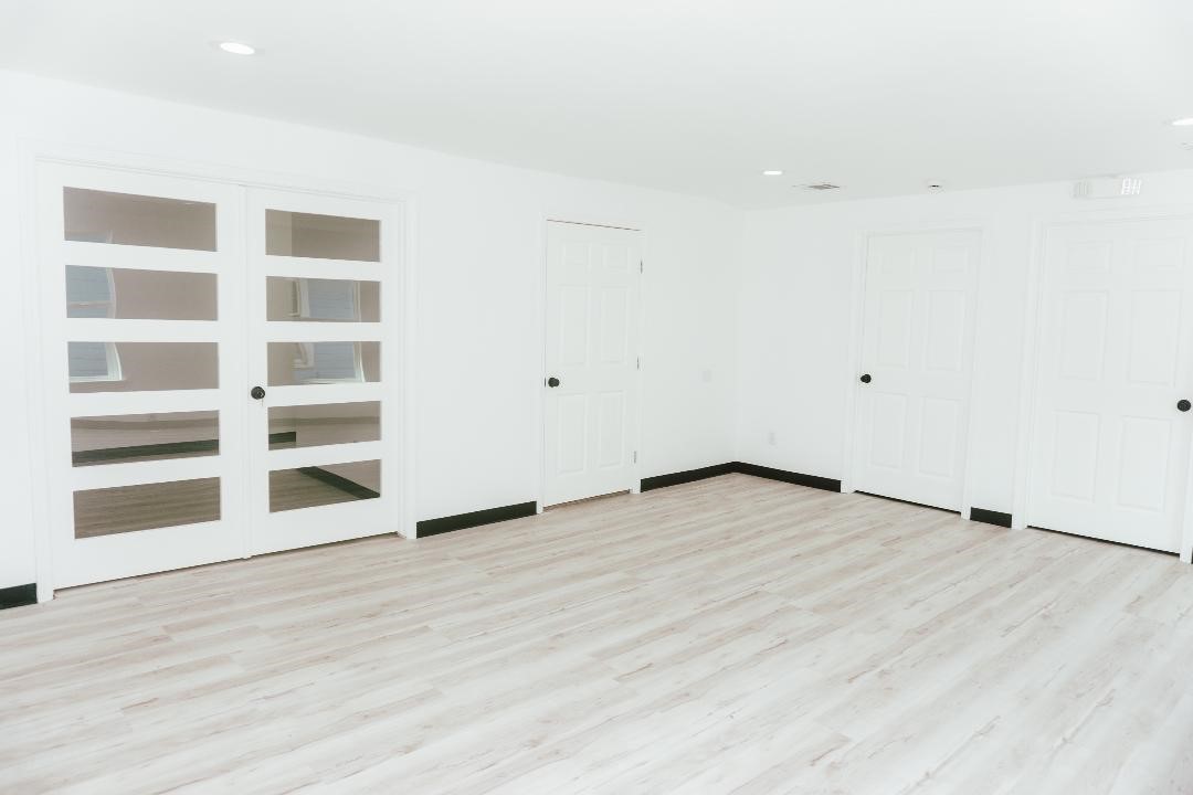 2513 Avenue H Rosenberg, TX 77471 - Photo 8 of 9 a view of an empty room with wooden floor and a window
