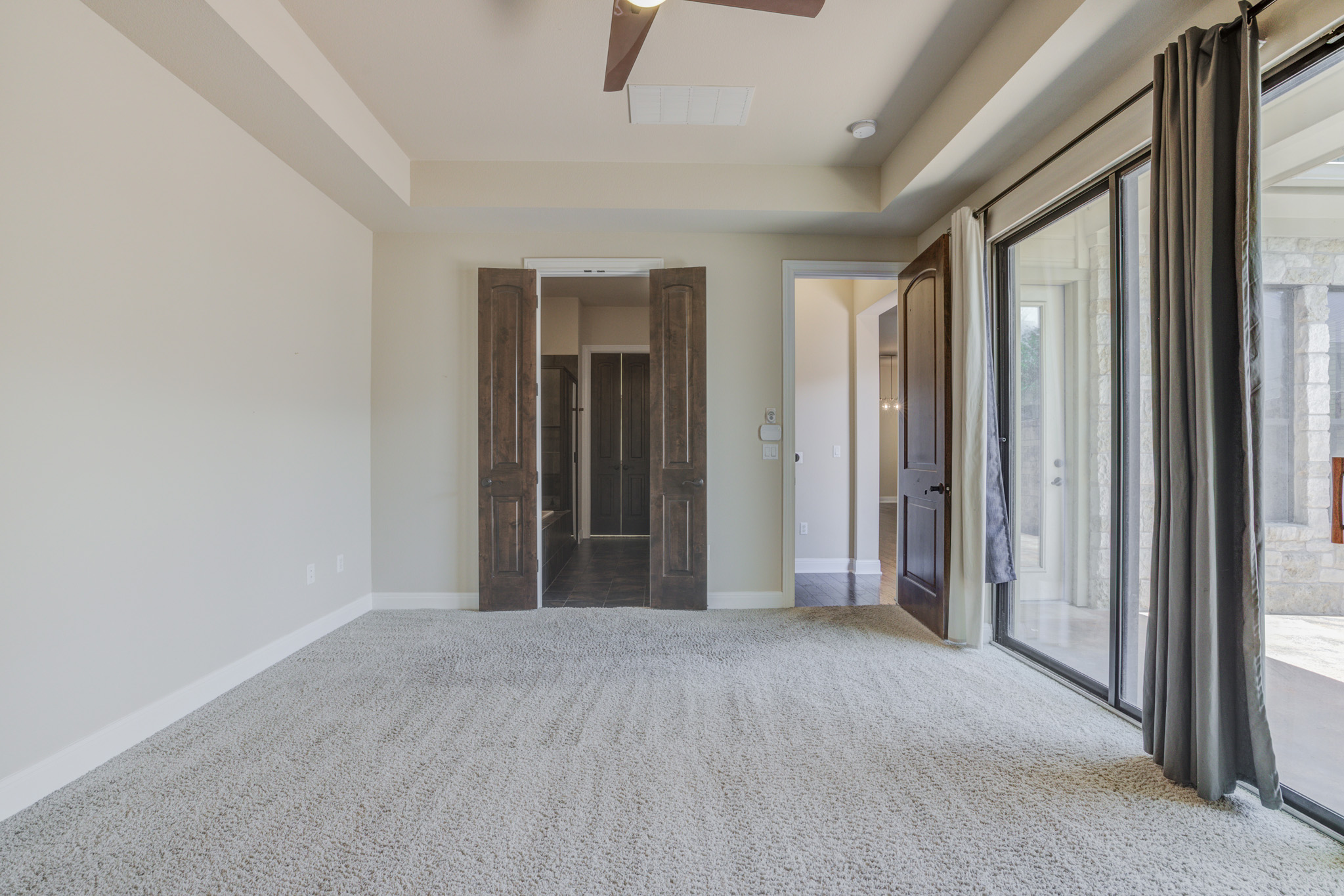 4524 Berkman Drive Austin, TX 78723 - Photo 22 of 38 Spacious owner suite featuring neutral carpeting, a ceiling fan, and recessed lighting