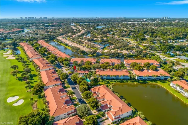 an aerial view of residential houses with outdoor space and lake view