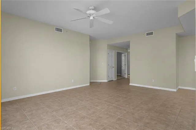 a view of an empty room with a ceiling fan