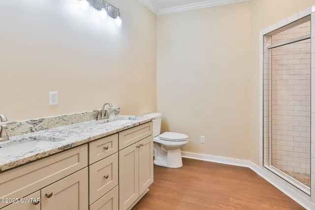 a bathroom with a granite countertop toilet and sink