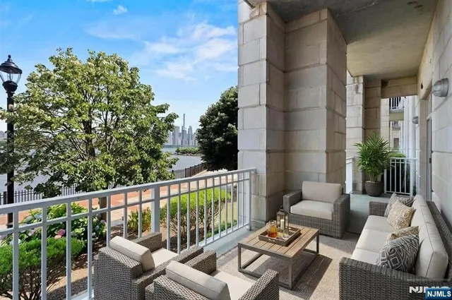 a roof deck with couches and wooden floor