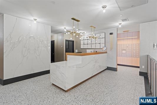 7400 River Road, Unit 116 North Bergen, NJ 07047 - Photo 17 of 32 a large room with chandelier and entryway