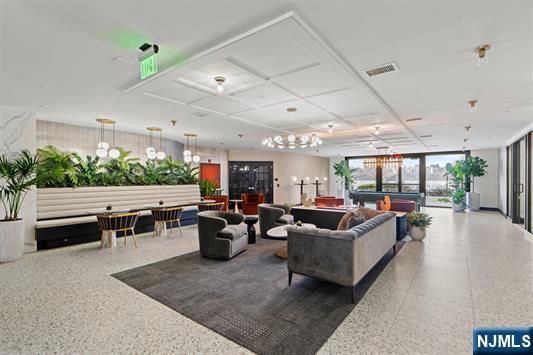 7400 River Road, Unit 116 North Bergen, NJ 07047 - Photo 19 of 32 a living room with furniture and a flat screen tv