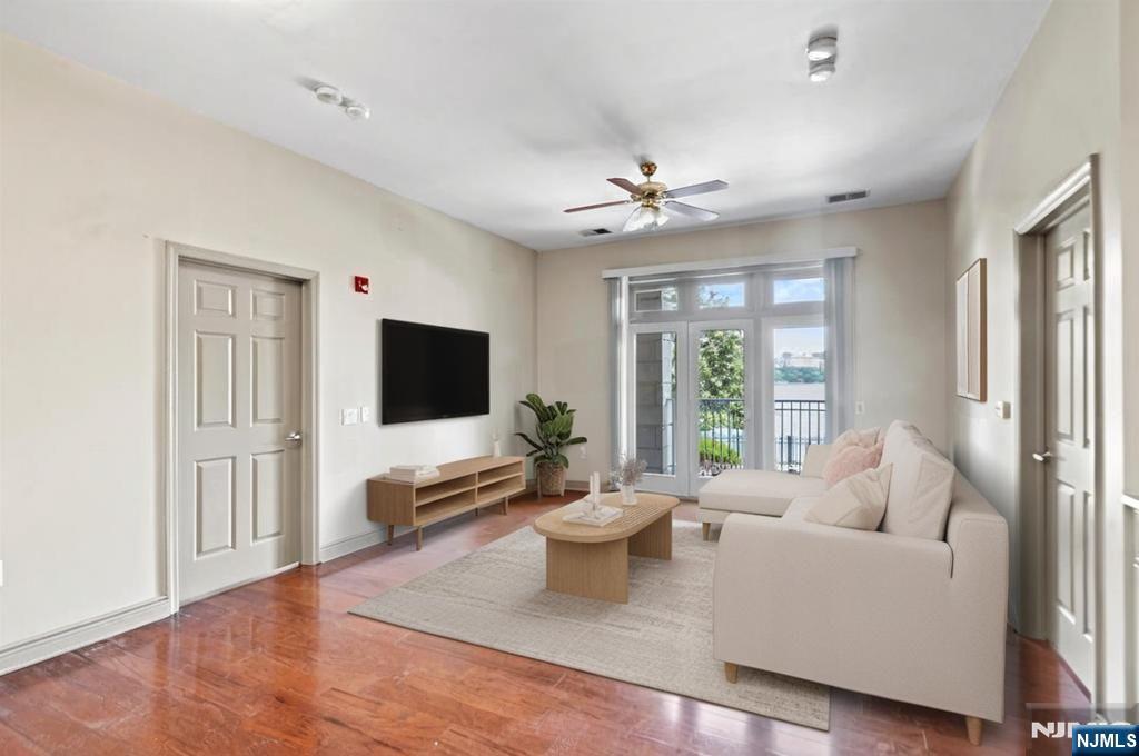 7400 River Road, Unit 116 North Bergen, NJ 07047 - Photo 2 of 32 a living room with furniture and a flat screen tv