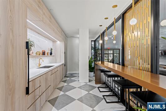 7400 River Road, Unit 116 North Bergen, NJ 07047 - Photo 22 of 32 a view of a hallway with wooden floor and windows