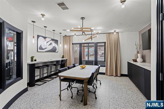 7400 River Road, Unit 116 North Bergen, NJ 07047 - Photo 24 of 32 a living room with a table chairs and a window