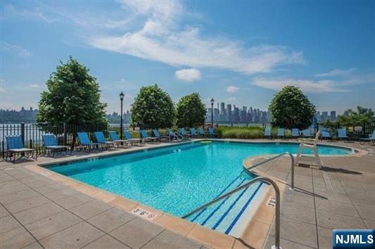 7400 River Road, Unit 116 North Bergen, NJ 07047 - Photo 26 of 32 a view of a swimming pool with a lounge chair