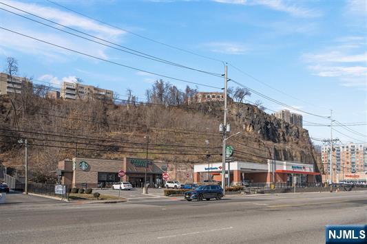 7400 River Road, Unit 116 North Bergen, NJ 07047 - Photo 29 of 32 a view of a building with a cars parked on the road