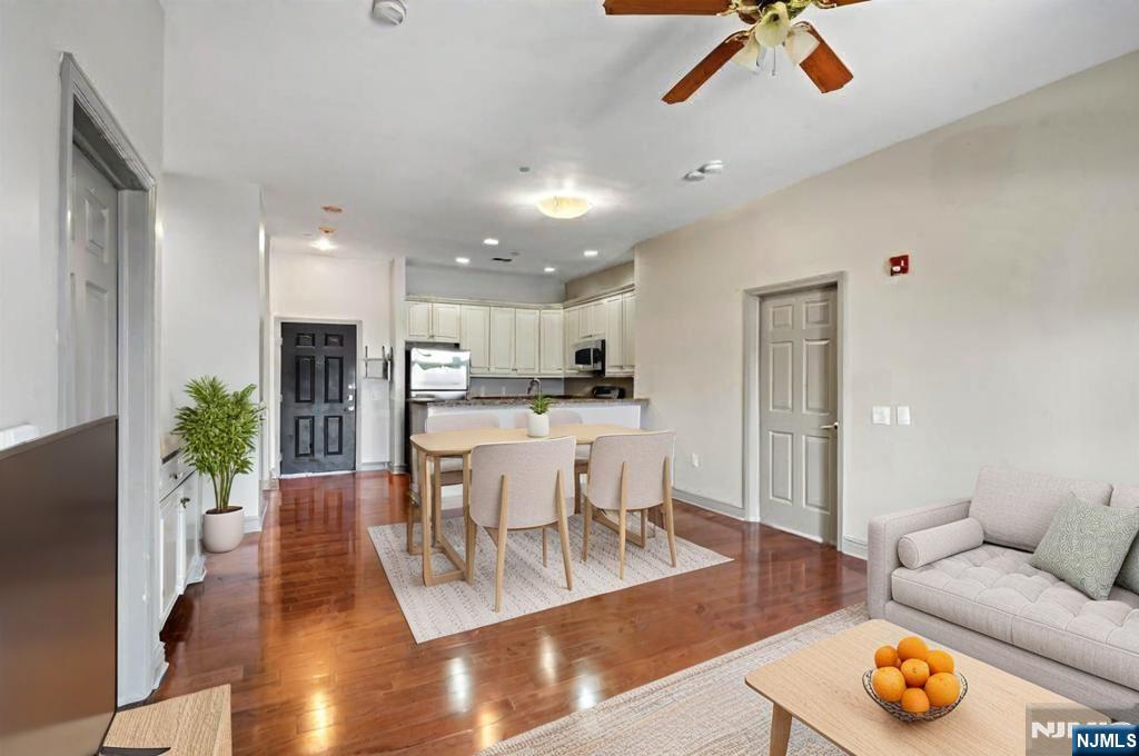 7400 River Road, Unit 116 North Bergen, NJ 07047 - Photo 3 of 32 a living room with furniture and kitchen view with wooden floor
