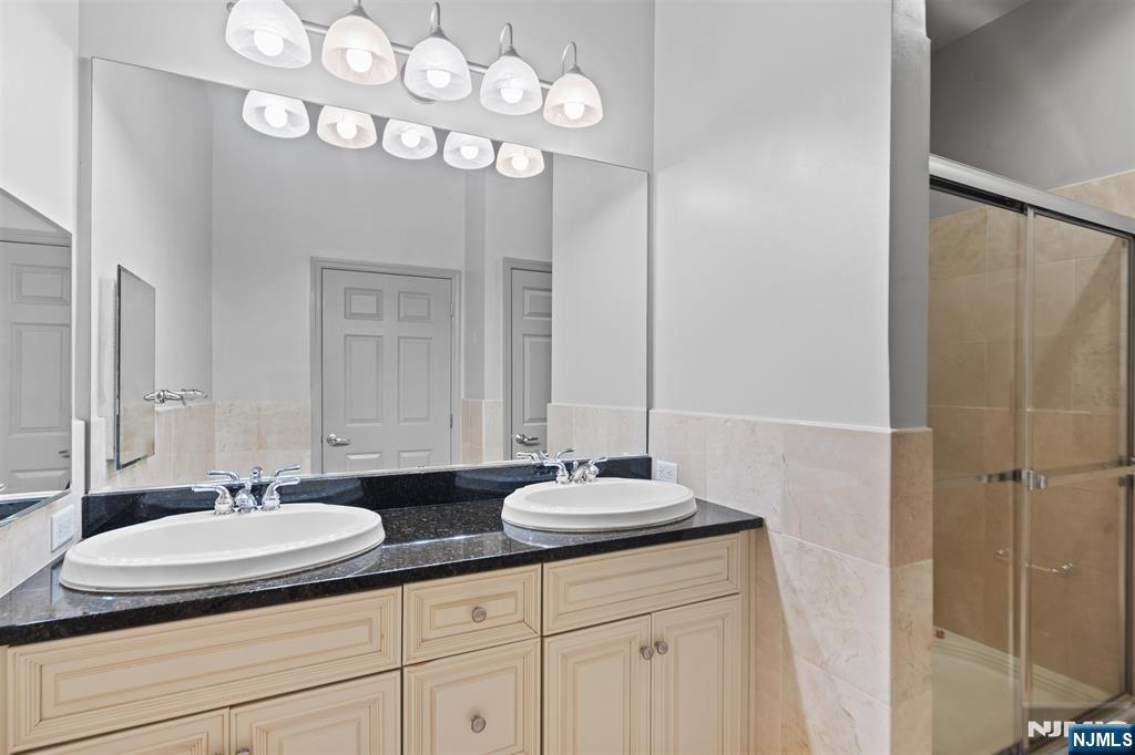 7400 River Road, Unit 116 North Bergen, NJ 07047 - Photo 9 of 32 a bathroom with a sink and a mirror