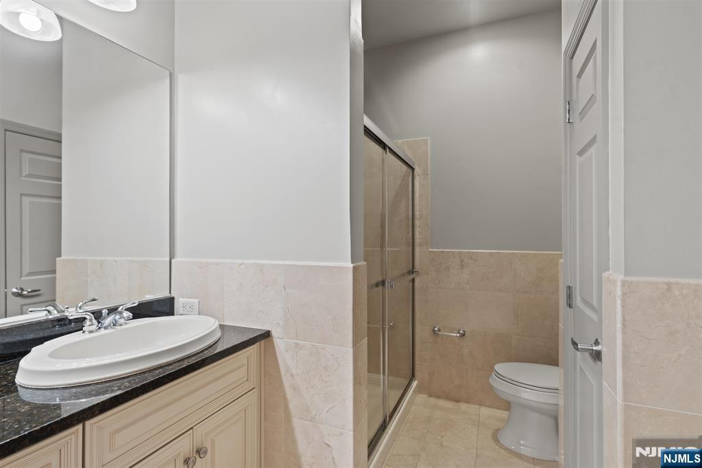 7400 River Road, Unit 116 North Bergen, NJ 07047 - Photo 10 of 32 a bathroom with a granite countertop sink toilet and shower