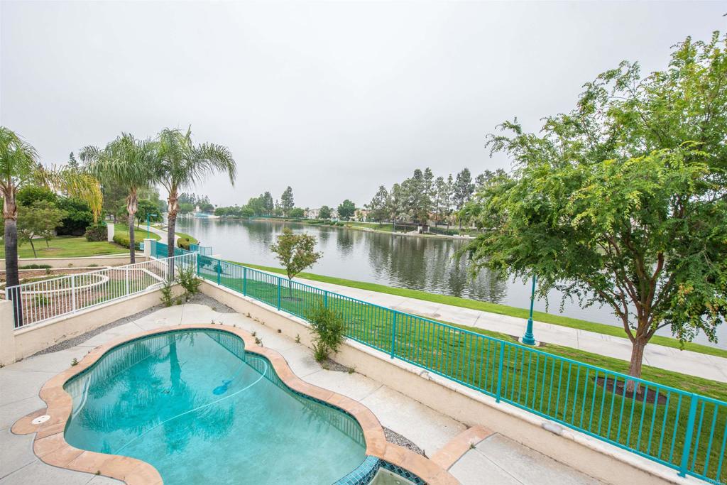 28679 Corte Capri Menifee, CA 92584 - Photo 2 of 66 a swimming pool with a yard and lake view