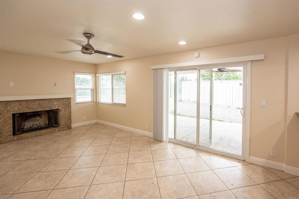 28679 Corte Capri Menifee, CA 92584 - Photo 28 of 66 a view of an empty room with a fireplace and a window