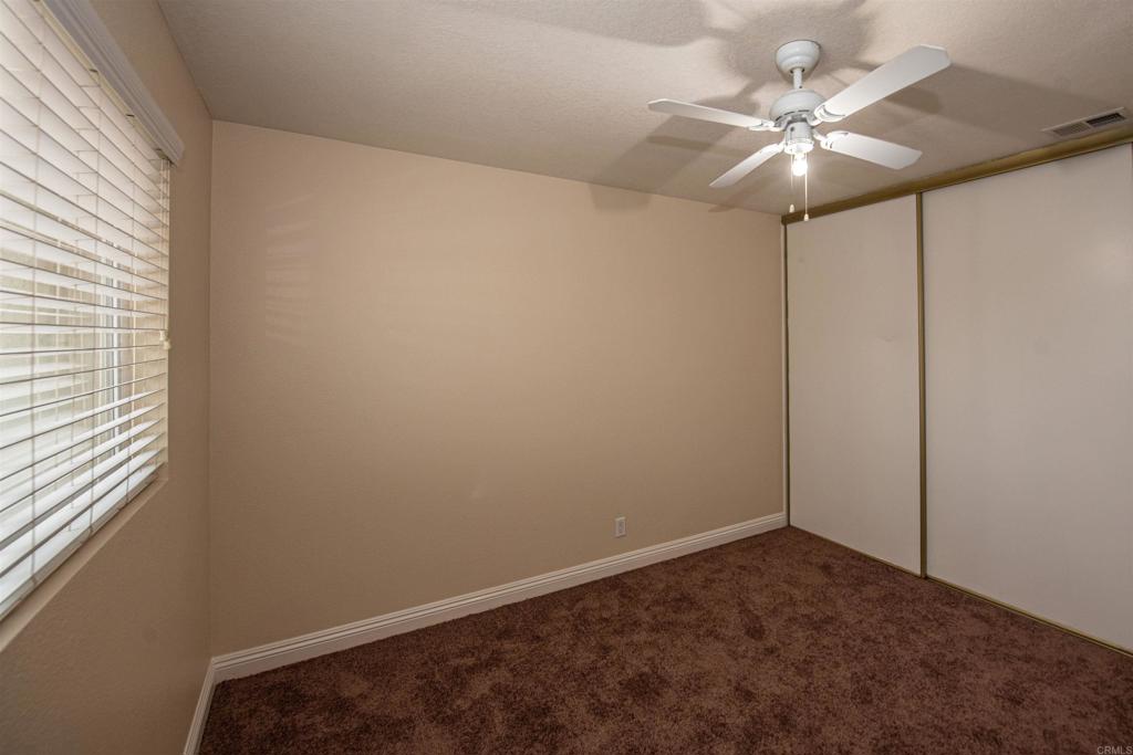 28679 Corte Capri Menifee, CA 92584 - Photo 37 of 66 an empty room with a window and a fan