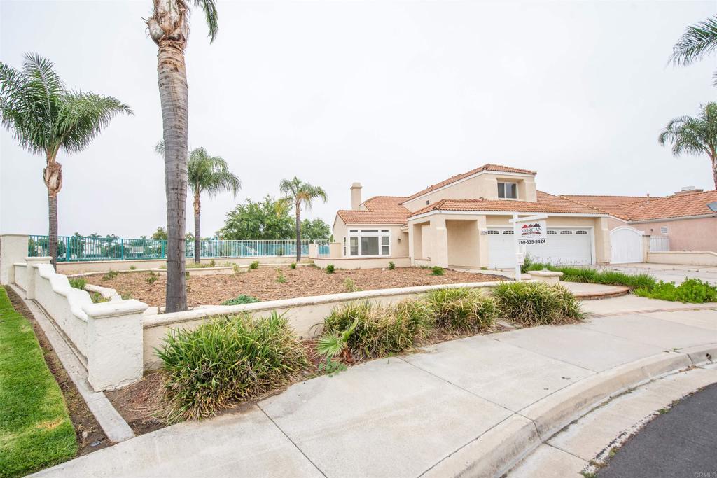28679 Corte Capri Menifee, CA 92584 - Photo 5 of 66 a front view of a house with a garden and lake view