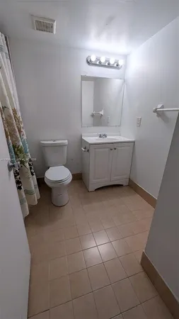 a bathroom with a sink mirror vanity and toilet
