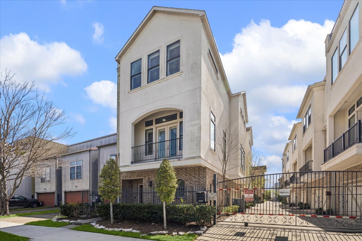 3123 Austin Street Houston, TX 77004 - Photo 1 of 24 a front view of a residential apartment building with a yard