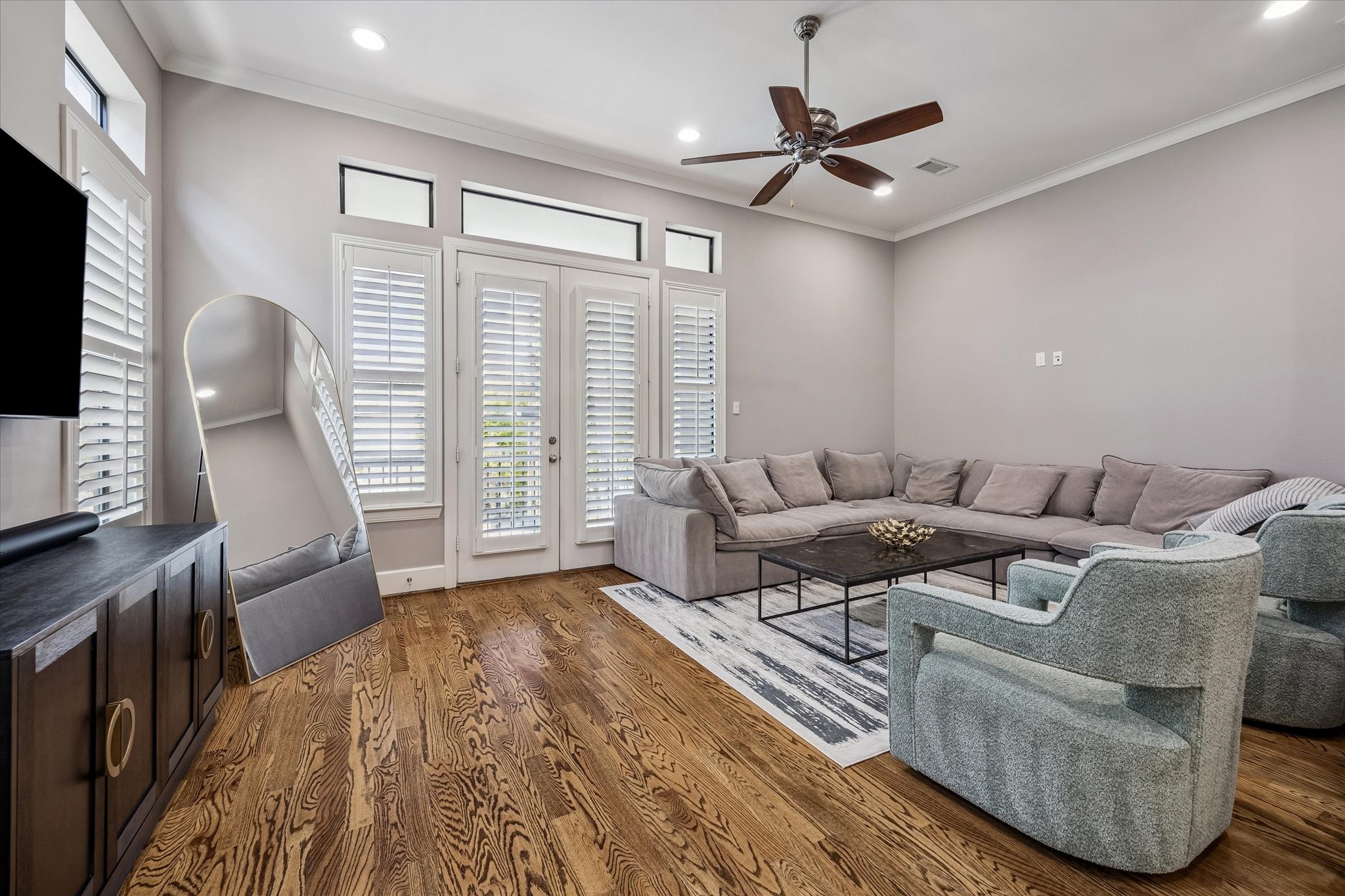 3123 Austin Street Houston, TX 77004 - Photo 12 of 24 a living room with furniture a large window and a flat screen tv