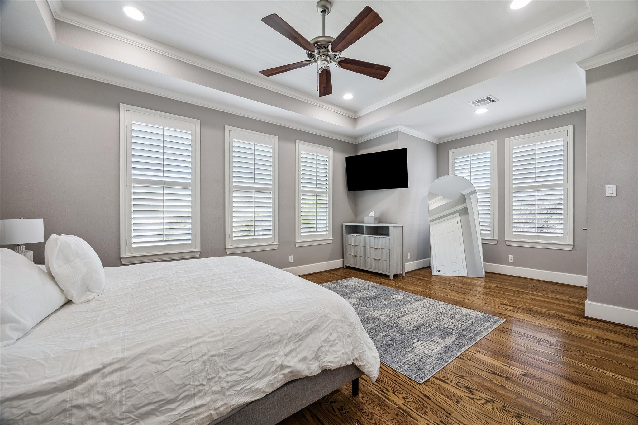 3123 Austin Street Houston, TX 77004 - Photo 14 of 24 a bedroom with a bed and a flat screen tv with wooden floor