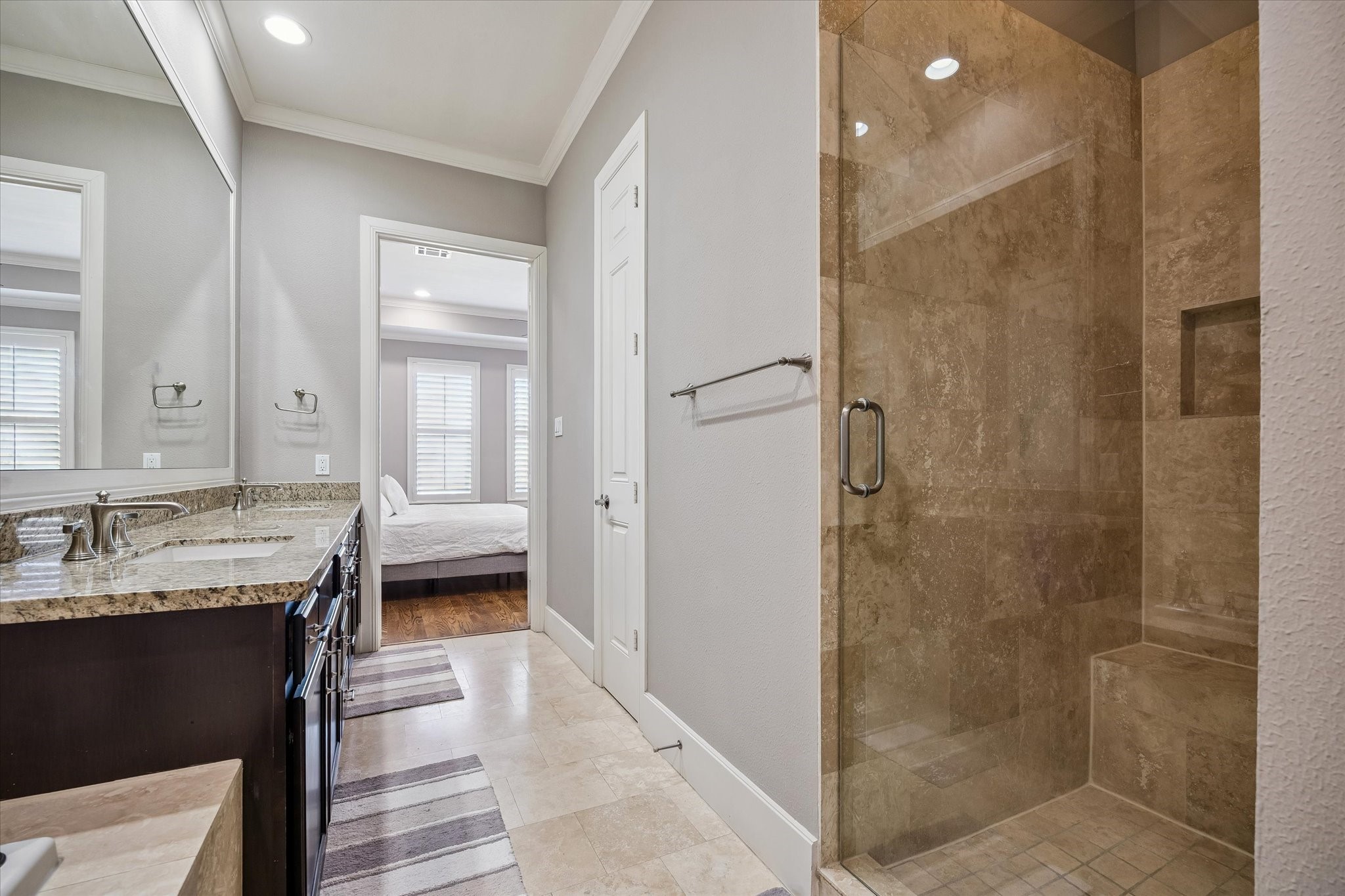 3123 Austin Street Houston, TX 77004 - Photo 16 of 24 a en suite bathroom with a granite countertop sink a mirror and a shower