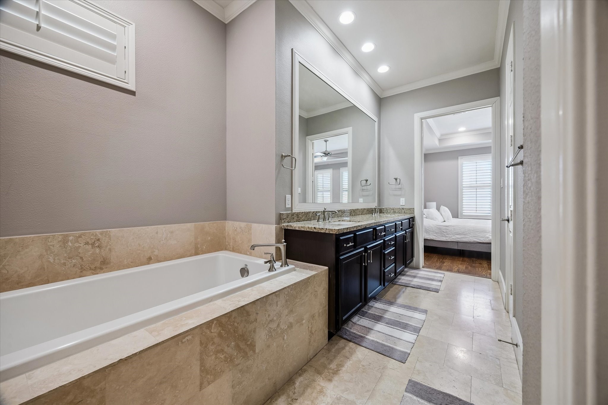 3123 Austin Street Houston, TX 77004 - Photo 17 of 24 a spacious bathroom with a tub double vanity and a sink