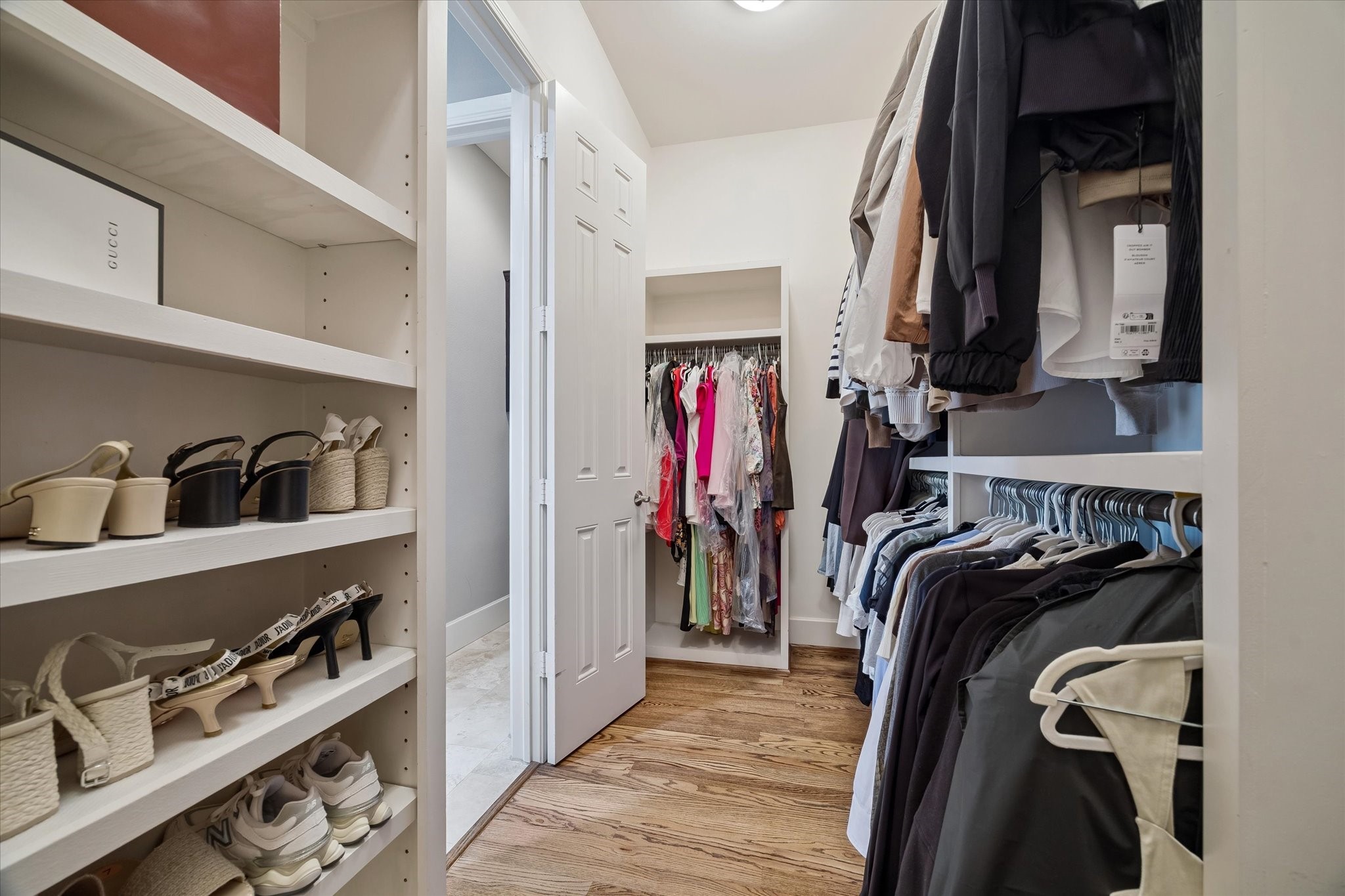 3123 Austin Street Houston, TX 77004 - Photo 19 of 24 a view of walk in closet with clothes and shoes
