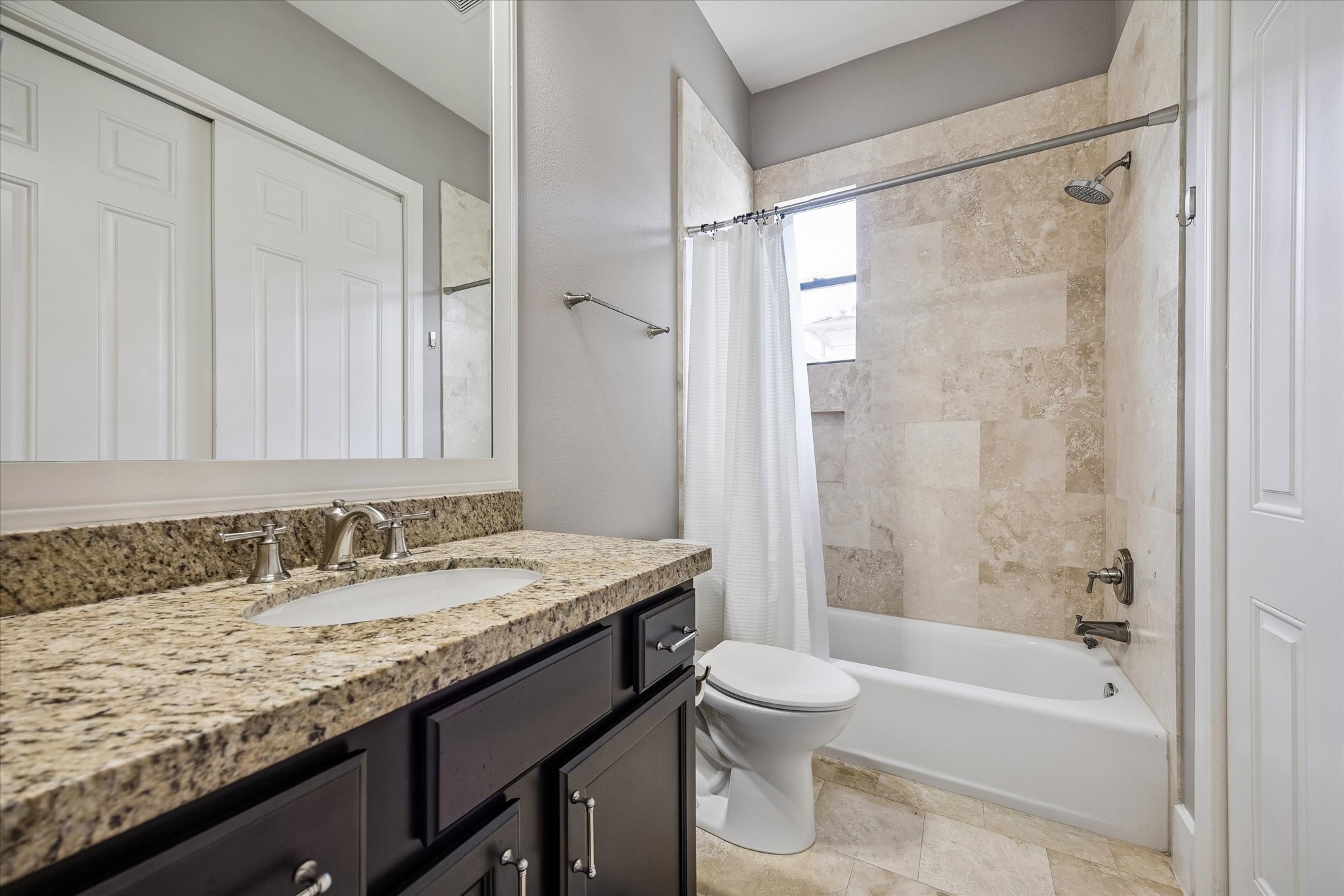 3123 Austin Street Houston, TX 77004 - Photo 21 of 24 a bathroom with a granite countertop sink toilet and shower