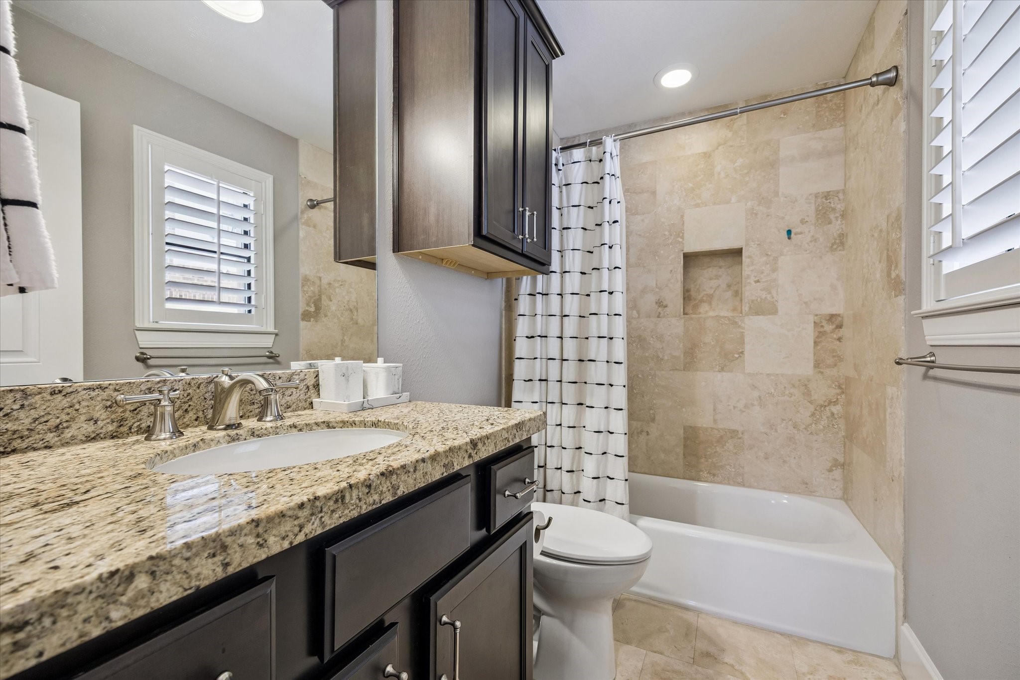 3123 Austin Street Houston, TX 77004 - Photo 5 of 24 a bathroom with a granite countertop bathtub sink vanity mirror and toilet