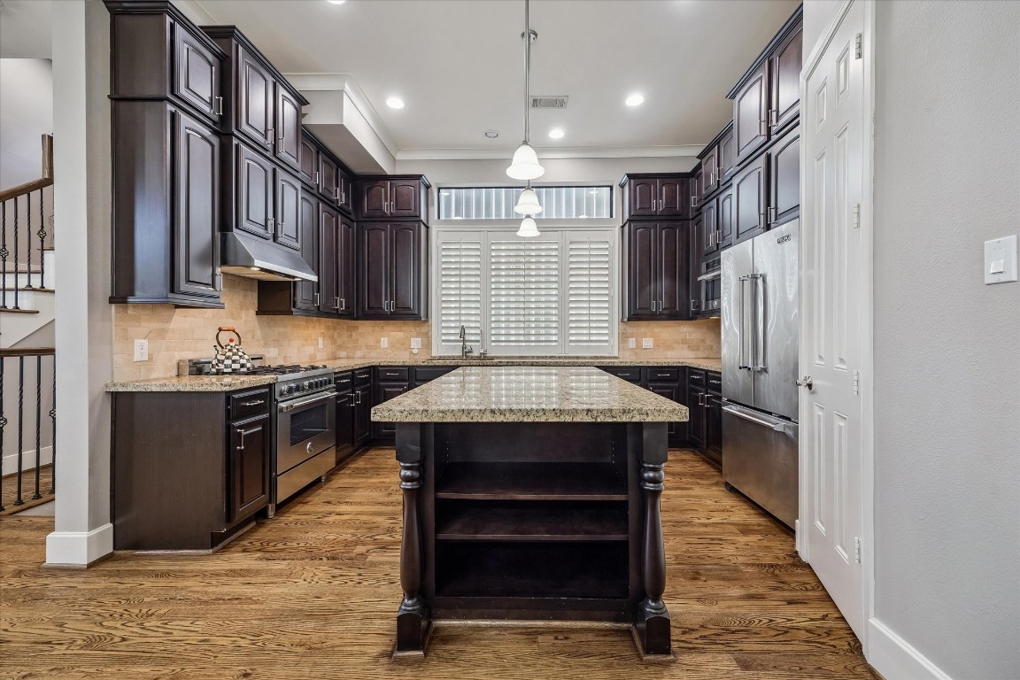3123 Austin Street Houston, TX 77004 - Photo 6 of 24 a kitchen with kitchen island a counter top space a sink stainless steel appliances and cabinets