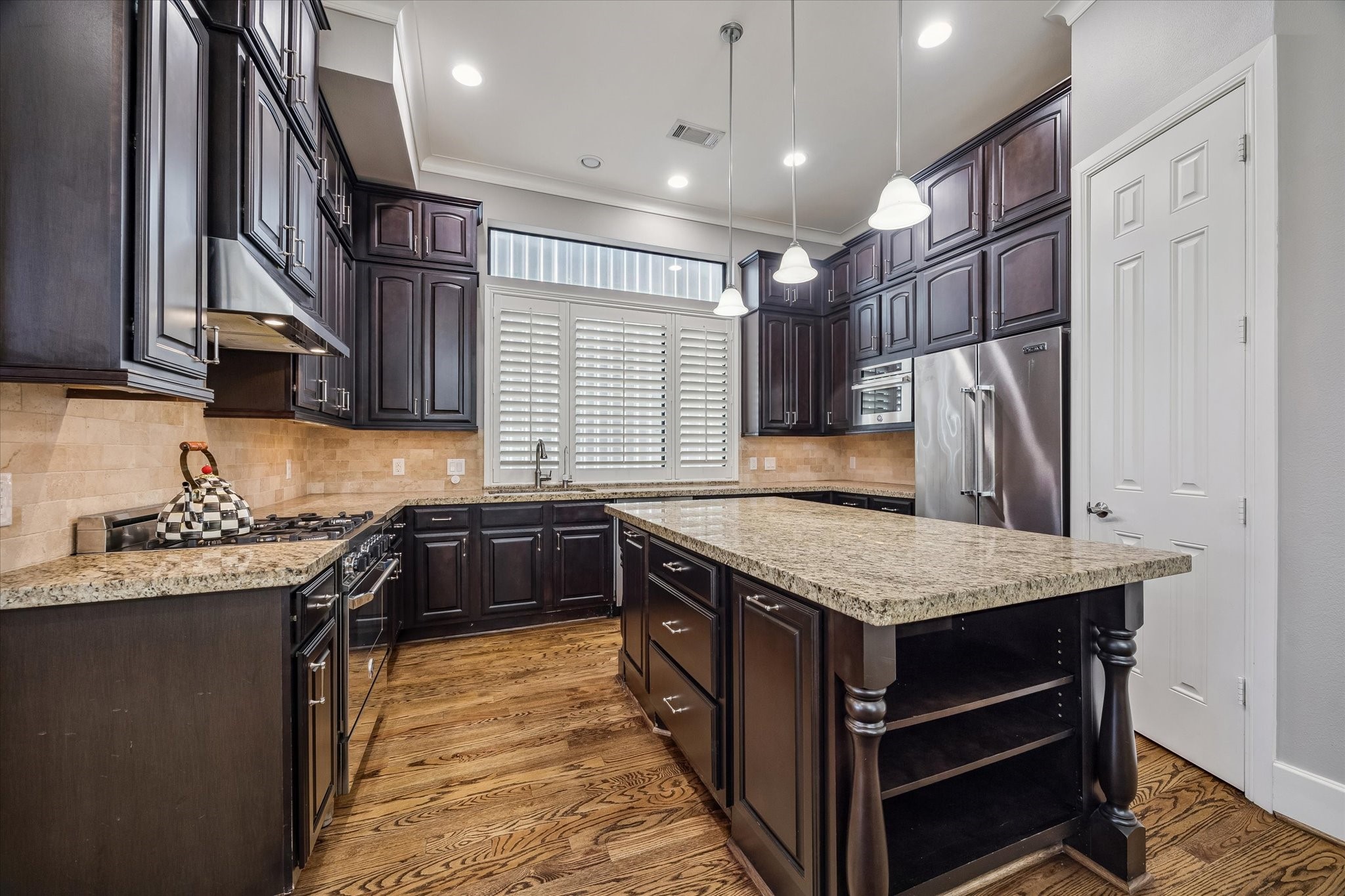3123 Austin Street Houston, TX 77004 - Photo 7 of 24 a kitchen with stainless steel appliances granite countertop a sink stove and cabinets