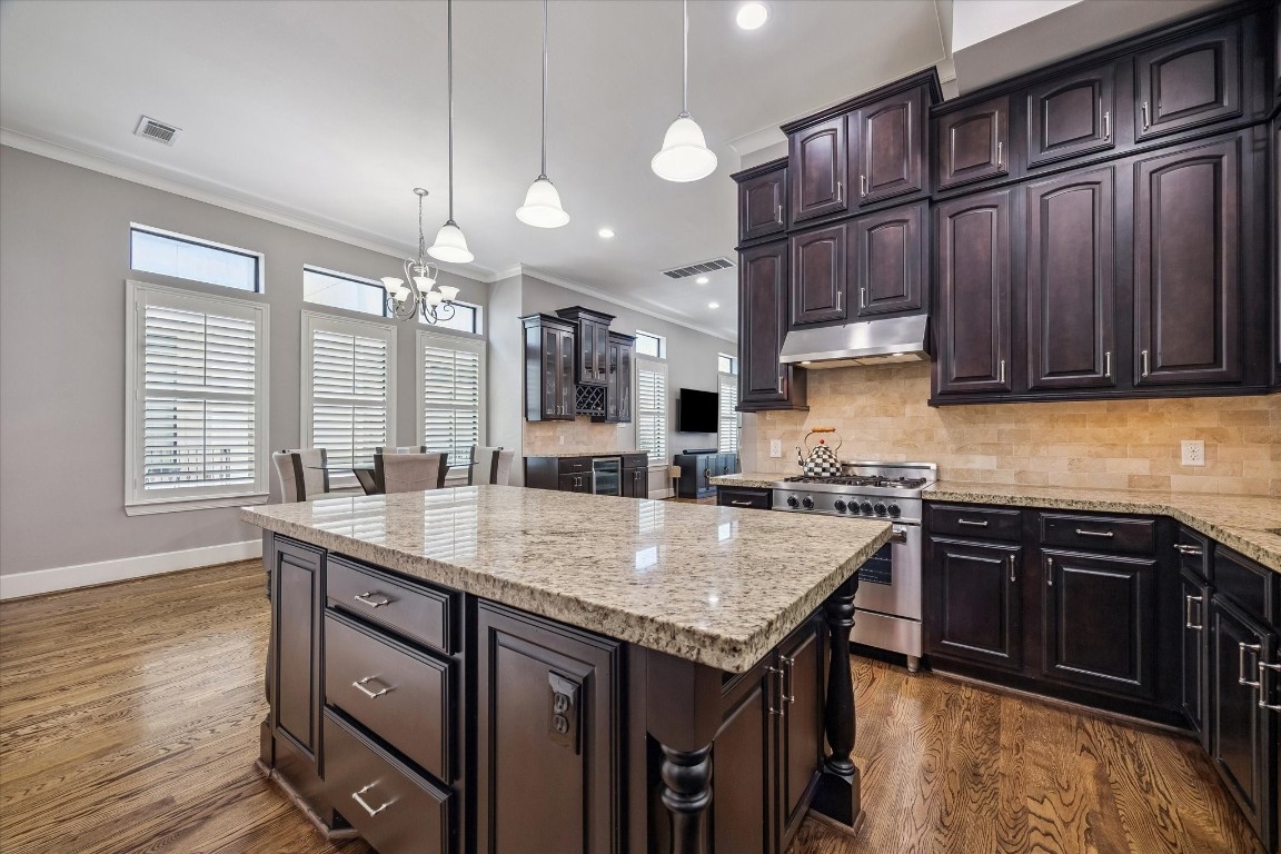 3123 Austin Street Houston, TX 77004 - Photo 8 of 24 a kitchen with granite countertop kitchen island a stove and a sink