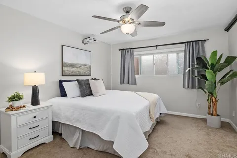 a bedroom with a large bed and a chandelier