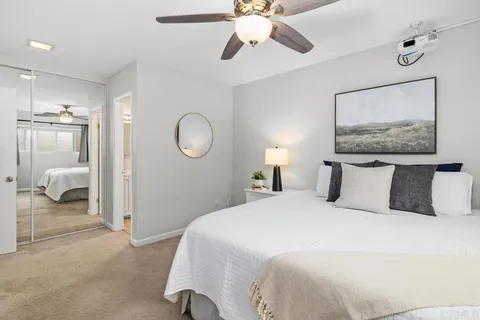 a bedroom with a large bed and a chandelier