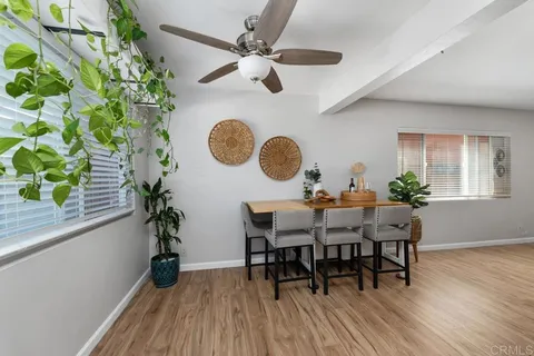 a dining room with furniture and wooden floor
