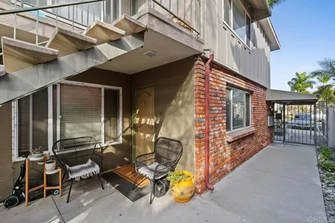 a view of a patio with a table and chairs