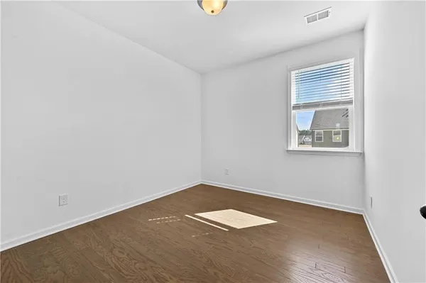 wooden floor in a hall with an empty room