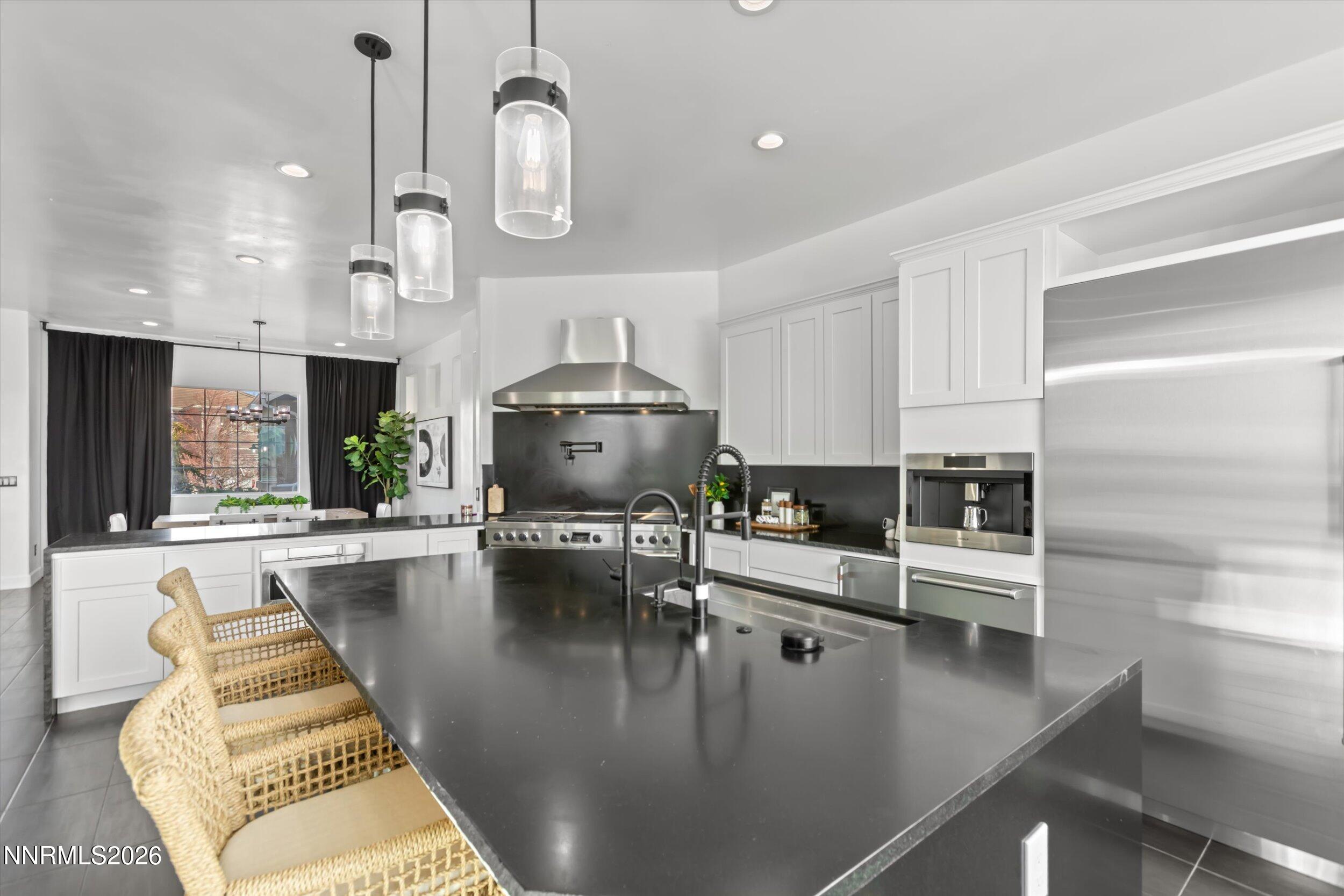 5850 Geode Court Reno, NV 89523 - Photo 11 of 88 a view of a kitchen with kitchen island stainless steel appliances
