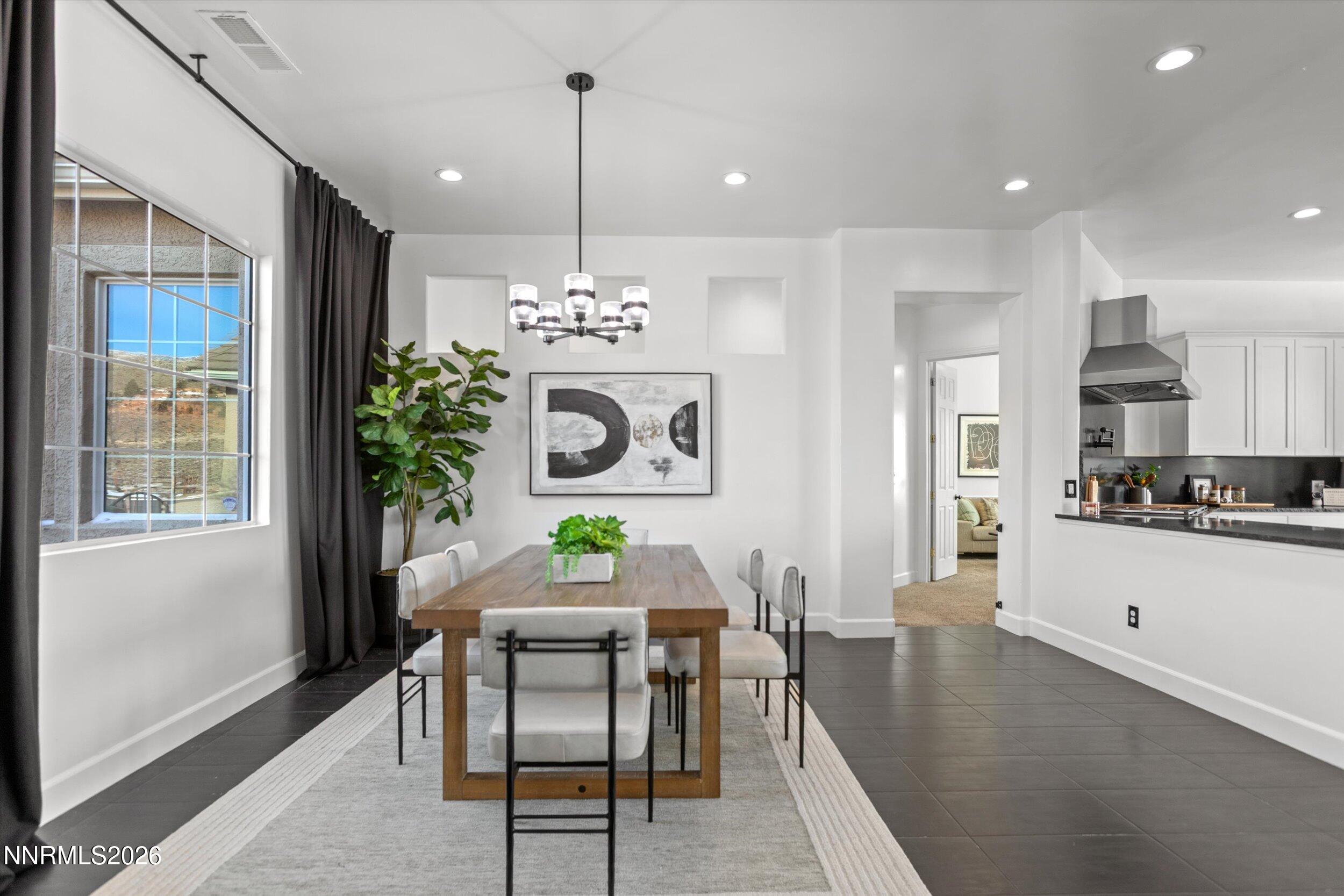 5850 Geode Court Reno, NV 89523 - Photo 21 of 88 a view of a dining room and livingroom with furniture wooden floor a chandelier