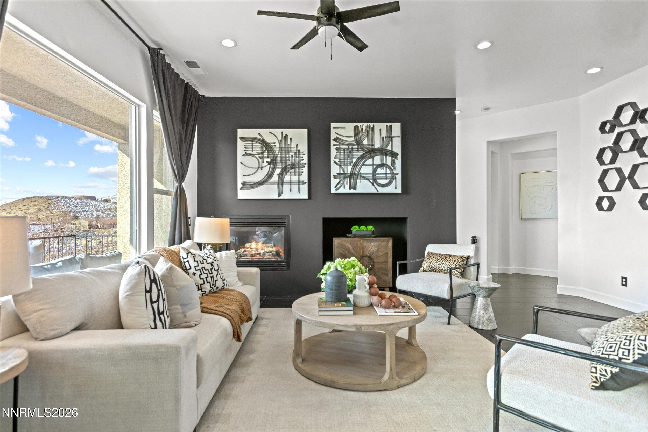 5850 Geode Court Reno, NV 89523 - Photo 3 of 88 a living room with furniture a fireplace and a large window