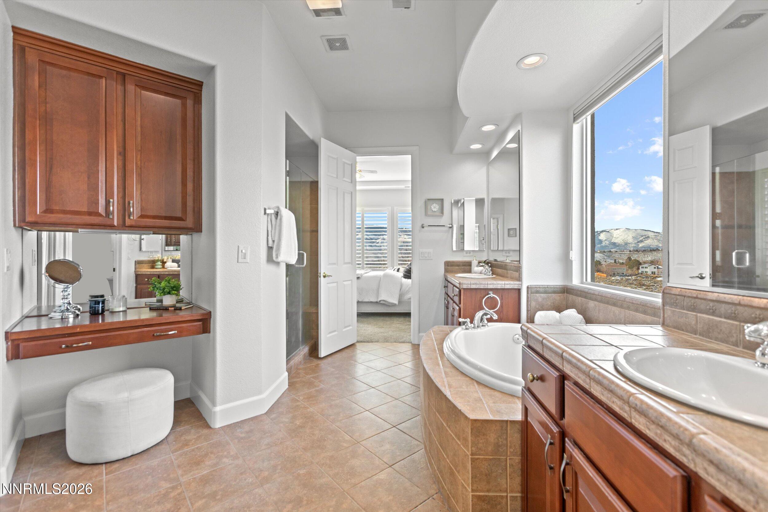 5850 Geode Court Reno, NV 89523 - Photo 31 of 88 a large bathroom with a granite countertop sink a toilet and bathtub