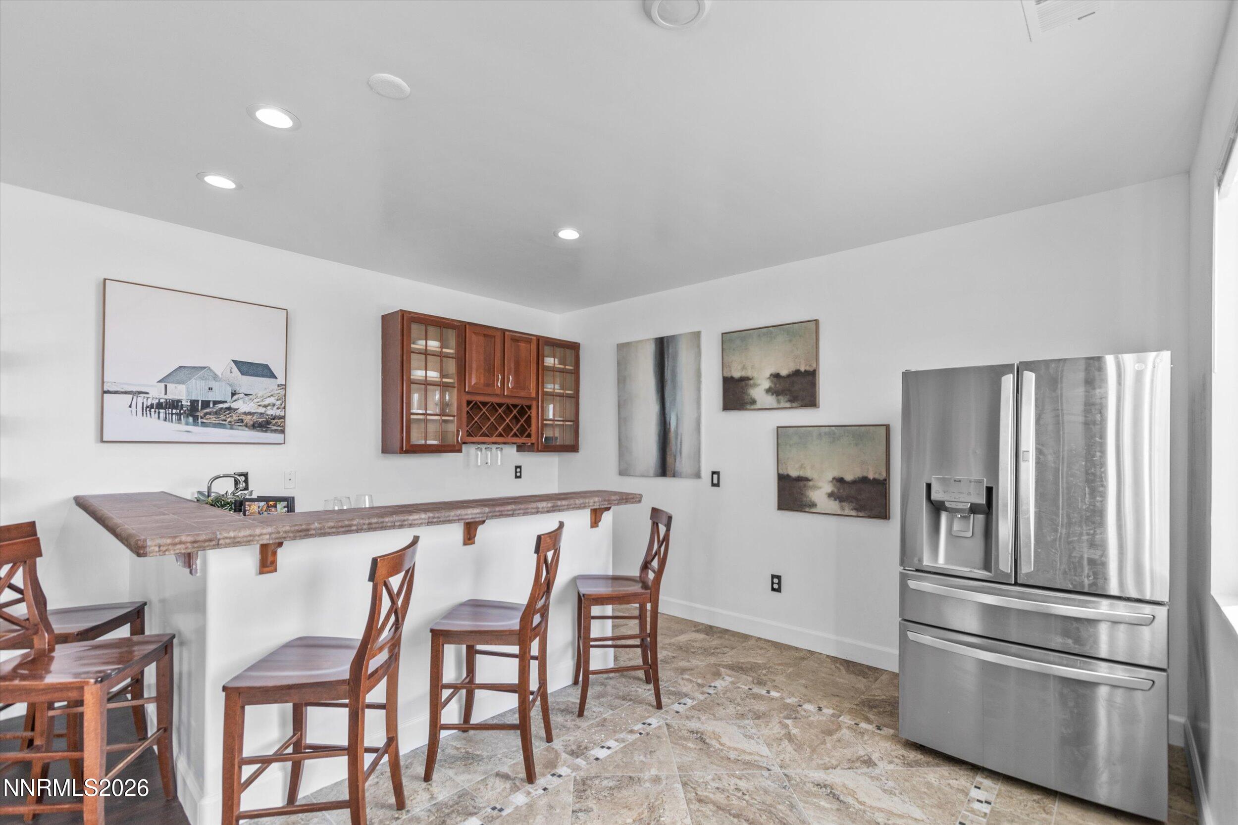 5850 Geode Court Reno, NV 89523 - Photo 49 of 88 a kitchen with stainless steel appliances a refrigerator and a dining table