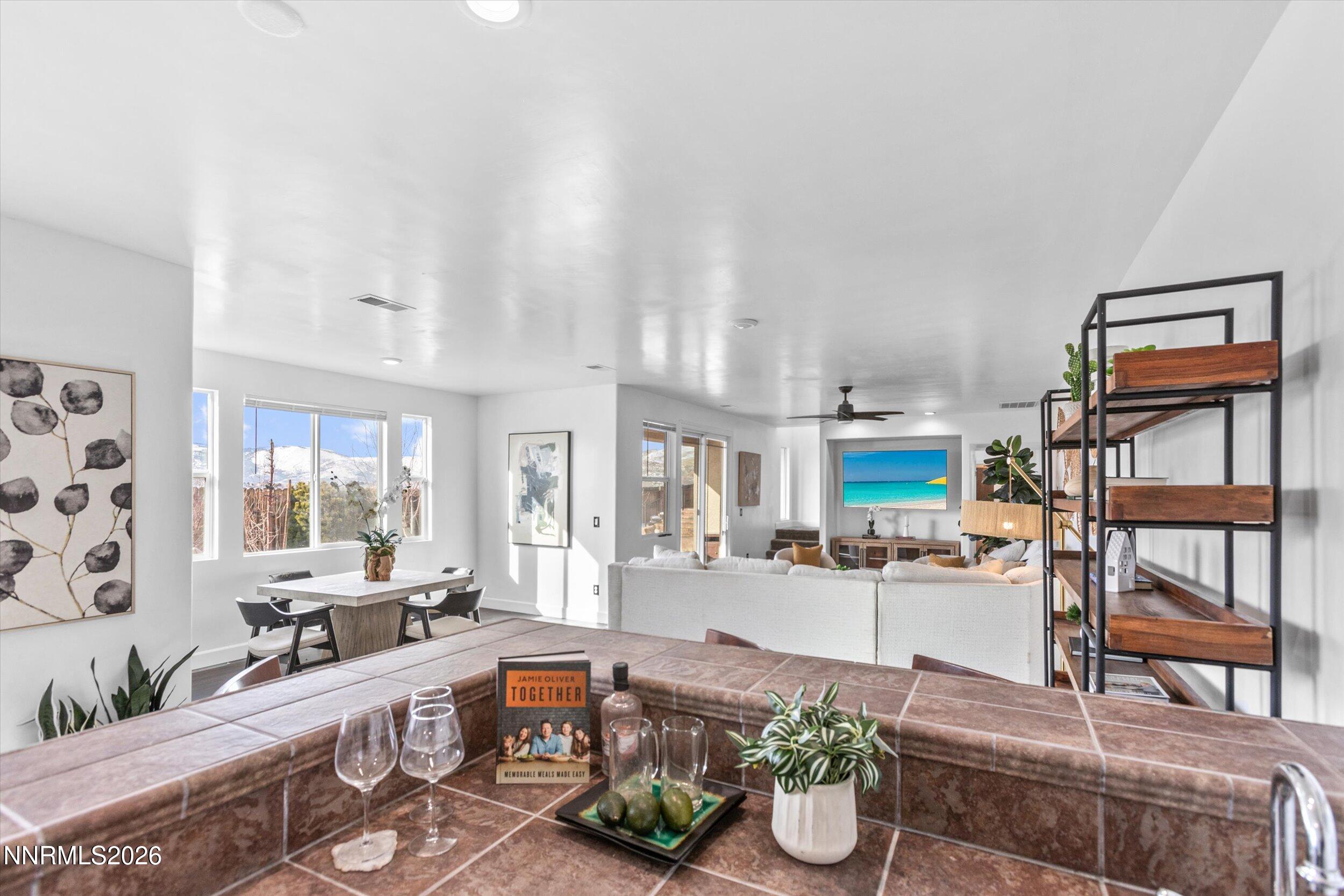 5850 Geode Court Reno, NV 89523 - Photo 51 of 88 a large living room with stainless steel appliances furniture a rug and a view of kitchen