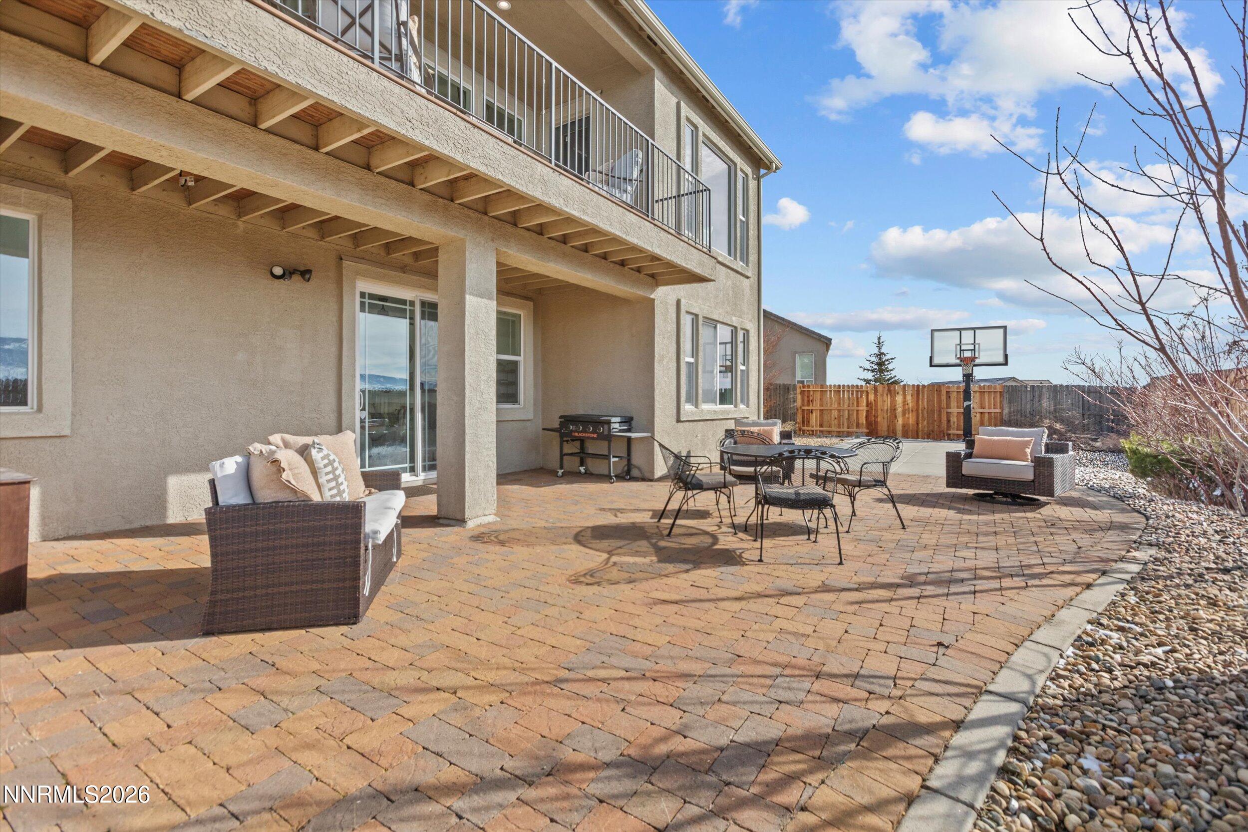 5850 Geode Court Reno, NV 89523 - Photo 66 of 88 a view of a patio with couches and table and chairs with wooden fence