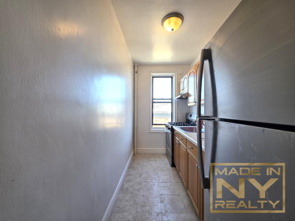 44-01 34th Avenue, Unit 4F Queens, NY 11101 - Photo 1 of 9 a view of hallway with windows