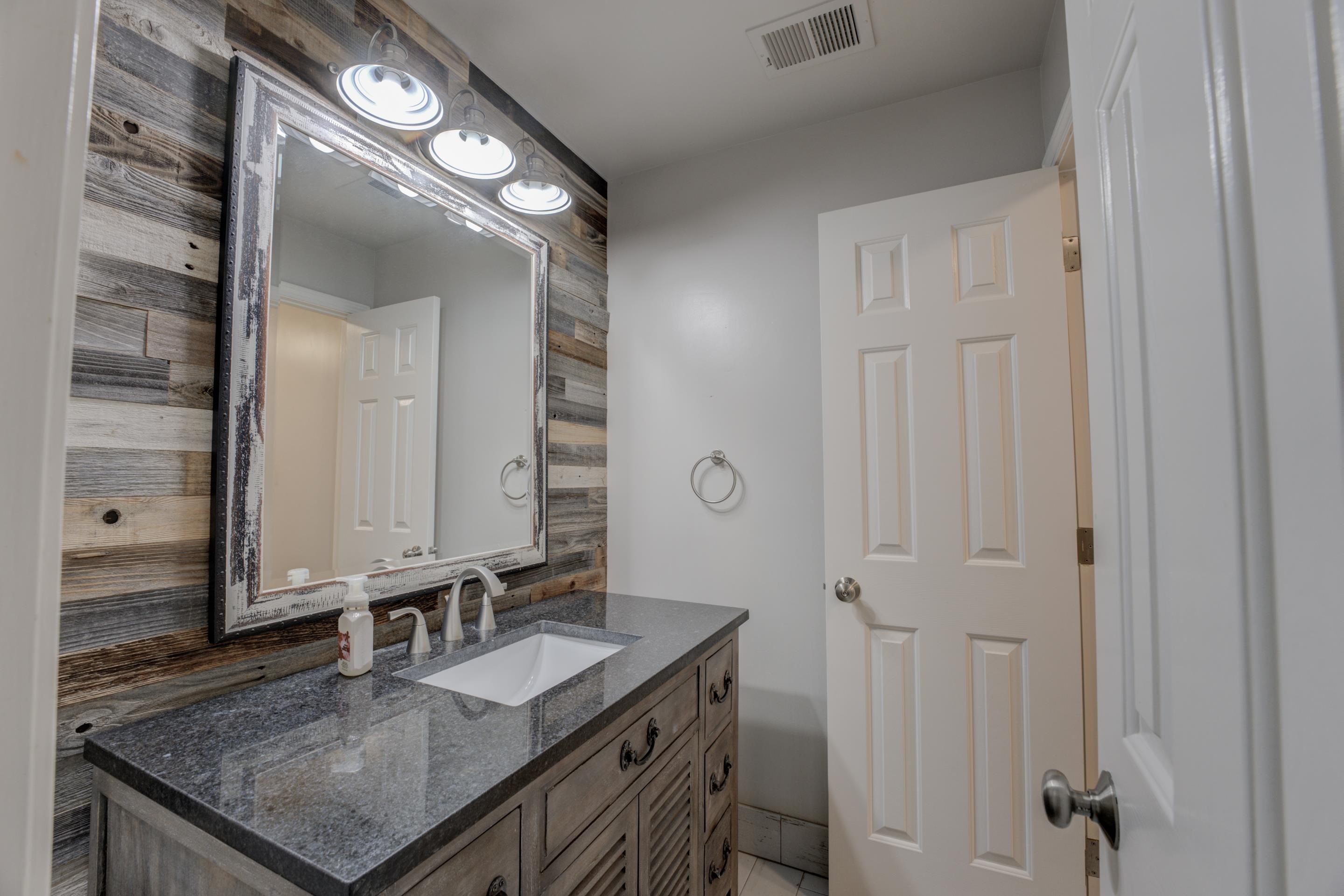 2142 Gallina Circle Collierville, TN 38017 - Photo 26 of 35 a bathroom with a granite countertop sink and a mirror