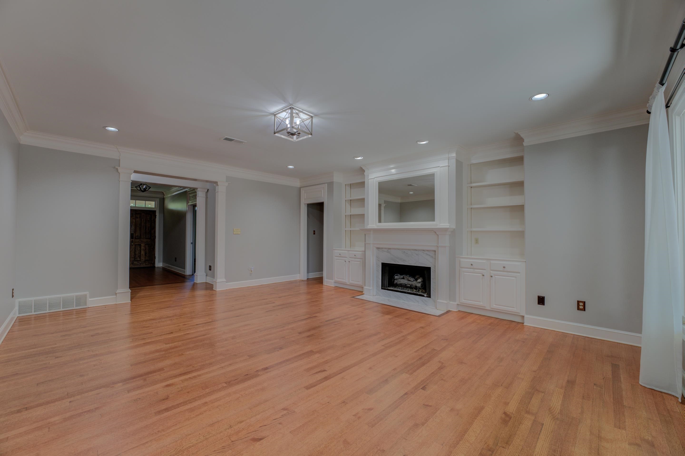 2142 Gallina Circle Collierville, TN 38017 - Photo 7 of 35 an empty room with wooden floor and fireplace