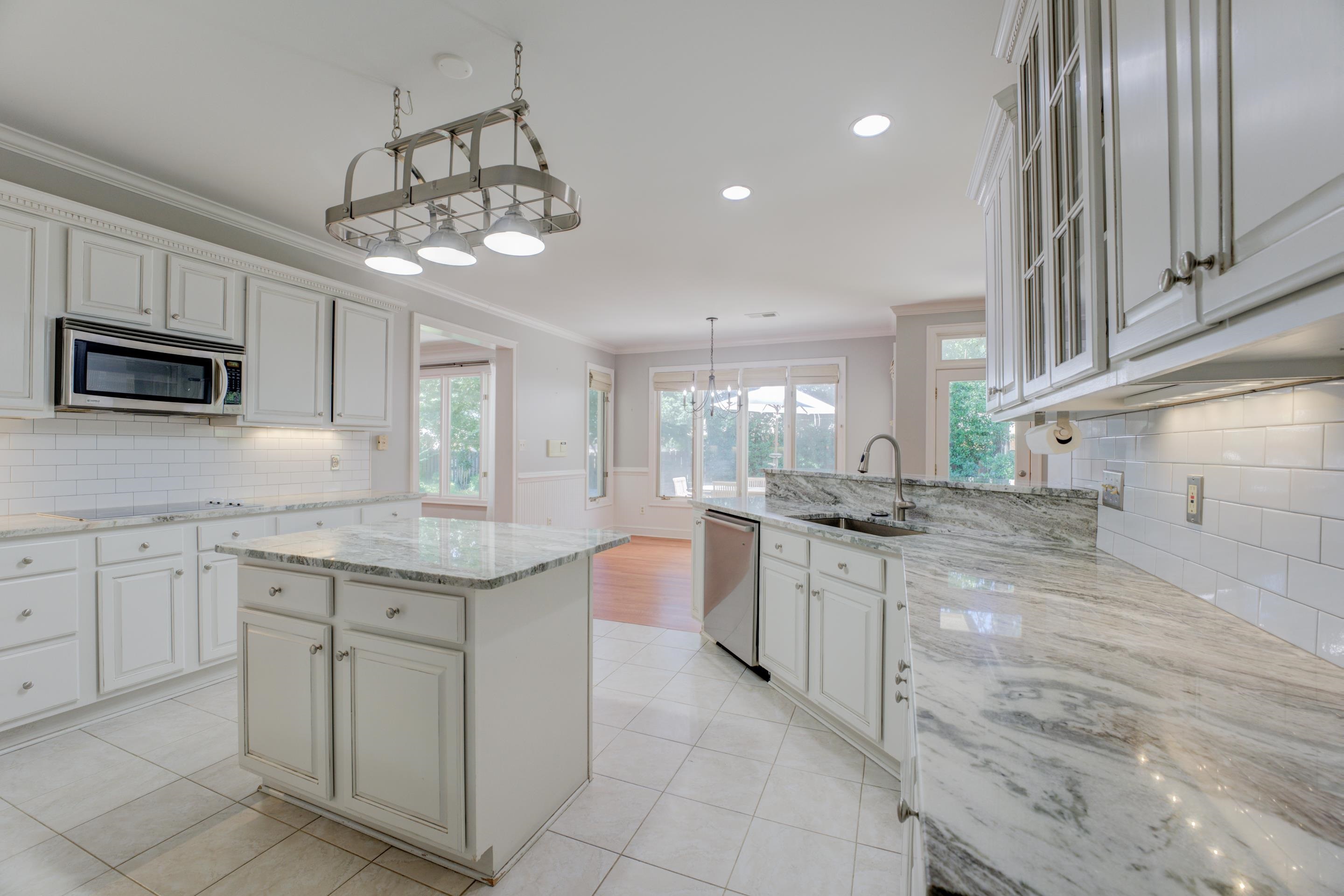 2142 Gallina Circle Collierville, TN 38017 - Photo 9 of 35 a kitchen with stainless steel appliances granite countertop a stove top oven a sink dishwasher and a refrigerator with wooden floor