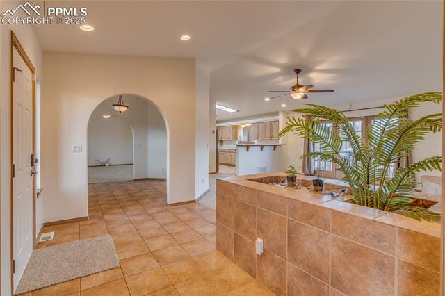 From double door entry to primary bedroom looking toward dining room - kitchen and family room to the right